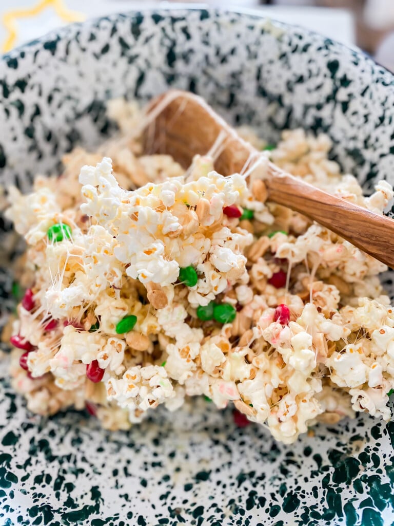 Christmas popcorn and M&M's being made into a tasty holiday treat.