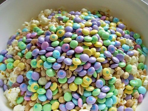 A big bowl filled with Popcorn-Cake-ingredients mixed-with-M&Ms A big bowl filled with Popcorn-Cake-ingredients mixed-with-M&Ms