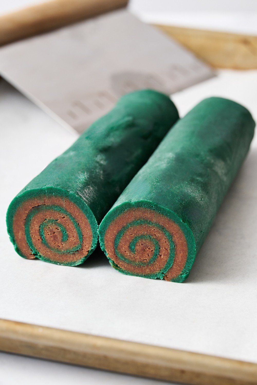 logs of pinwheel cookies split in half before slicing and baking.