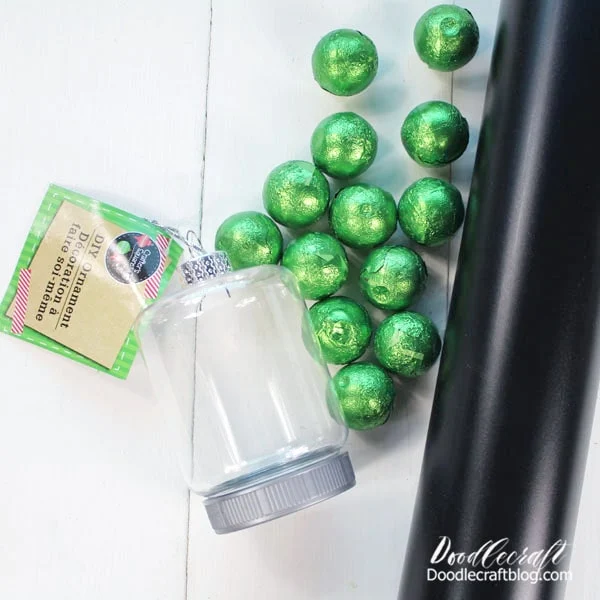 Supplies Needed for Grinch Face Ornament: Fillable Ornament (This one is from Dollar Tree) Black Vinyl Green Candy (or rolls of cash) Cricut Machine Transfer Tape