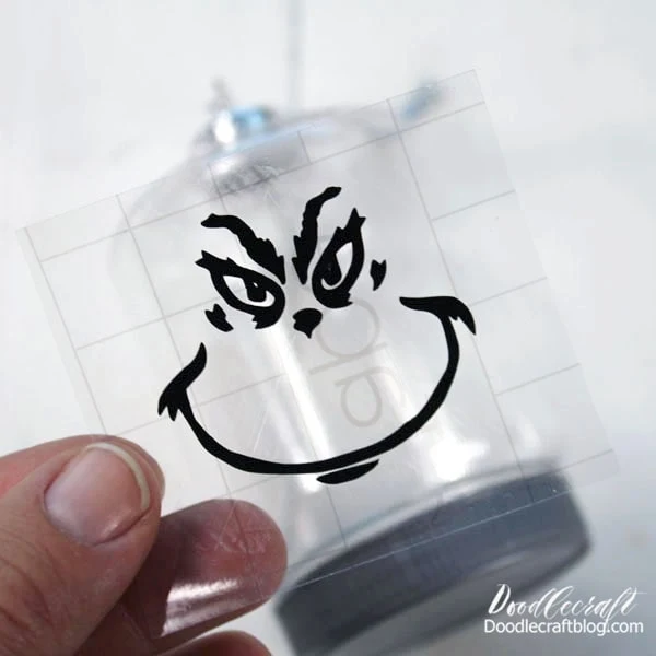 Peel off the white backing, leaving the vinyl adhered to the transfer tape. Then place it on the ornament.