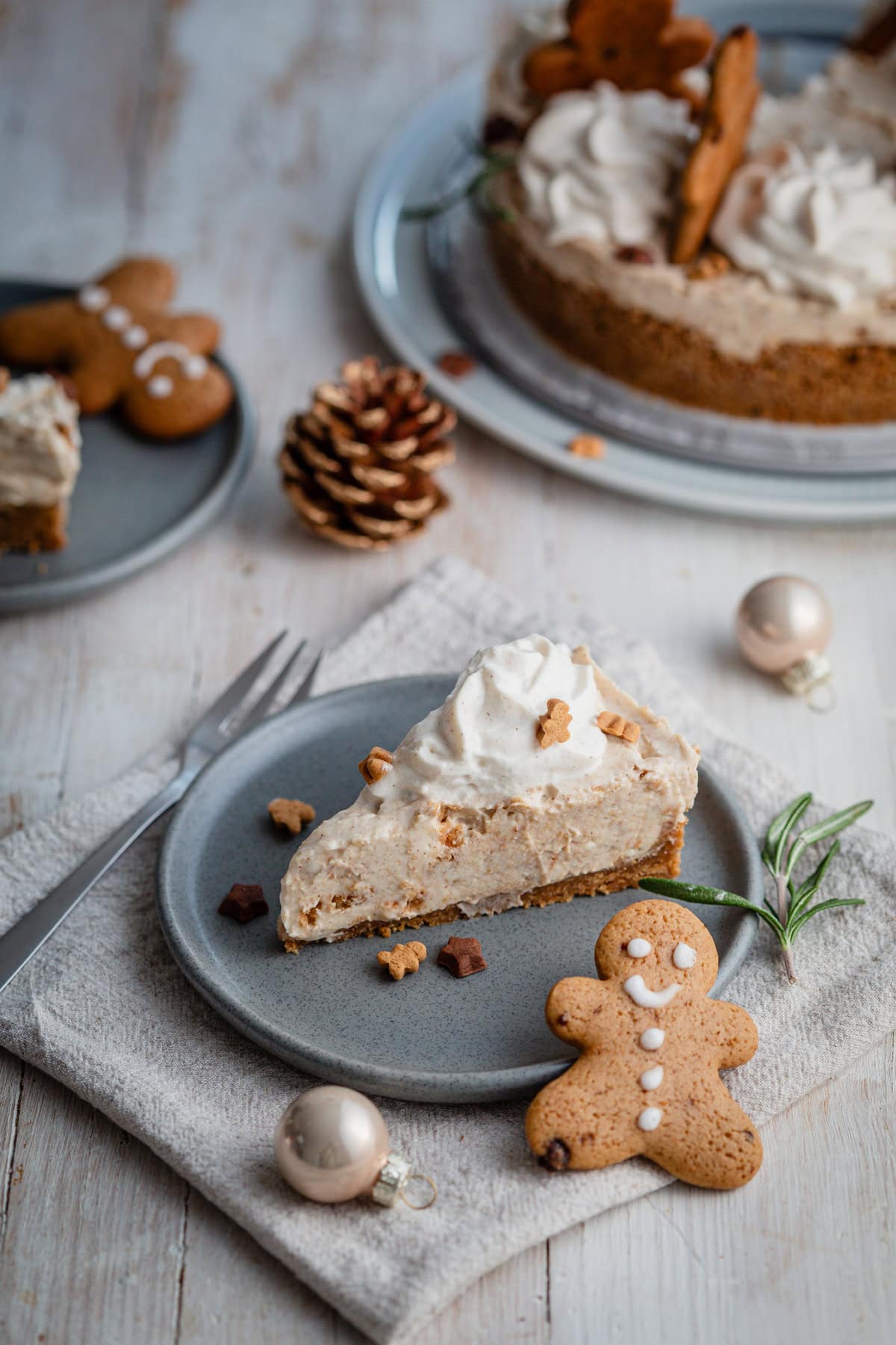 a slice of gingerbread cheesecake next to decoration