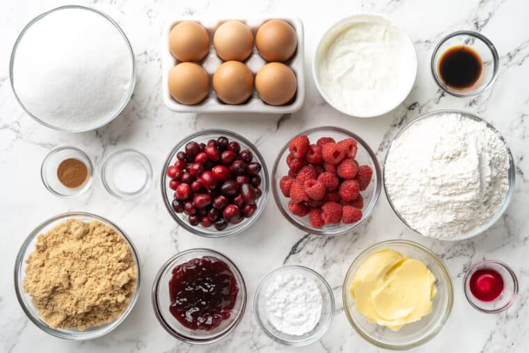 Ingredients to make cranberry bundt cake on the table in glass bowls.