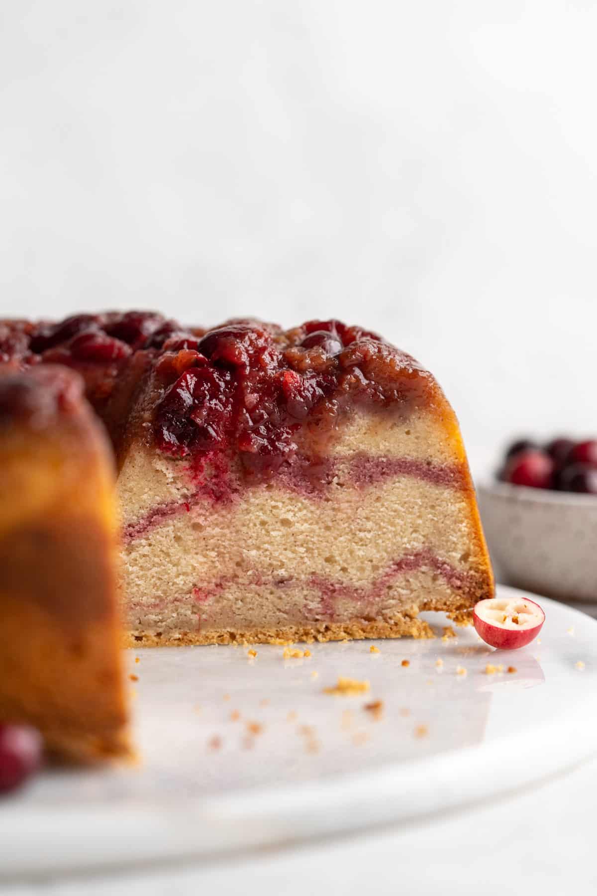 A straight shot of the cake cut with piece missing to show swirled inside.