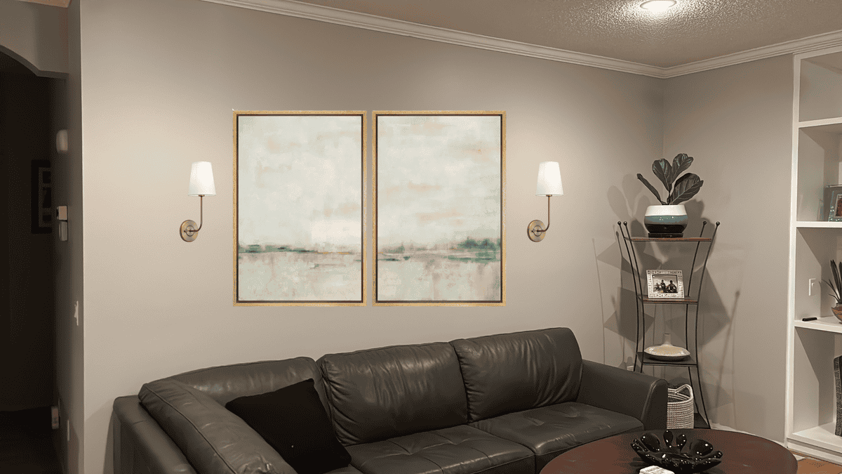 adding two large art pieces over a couch with sconces