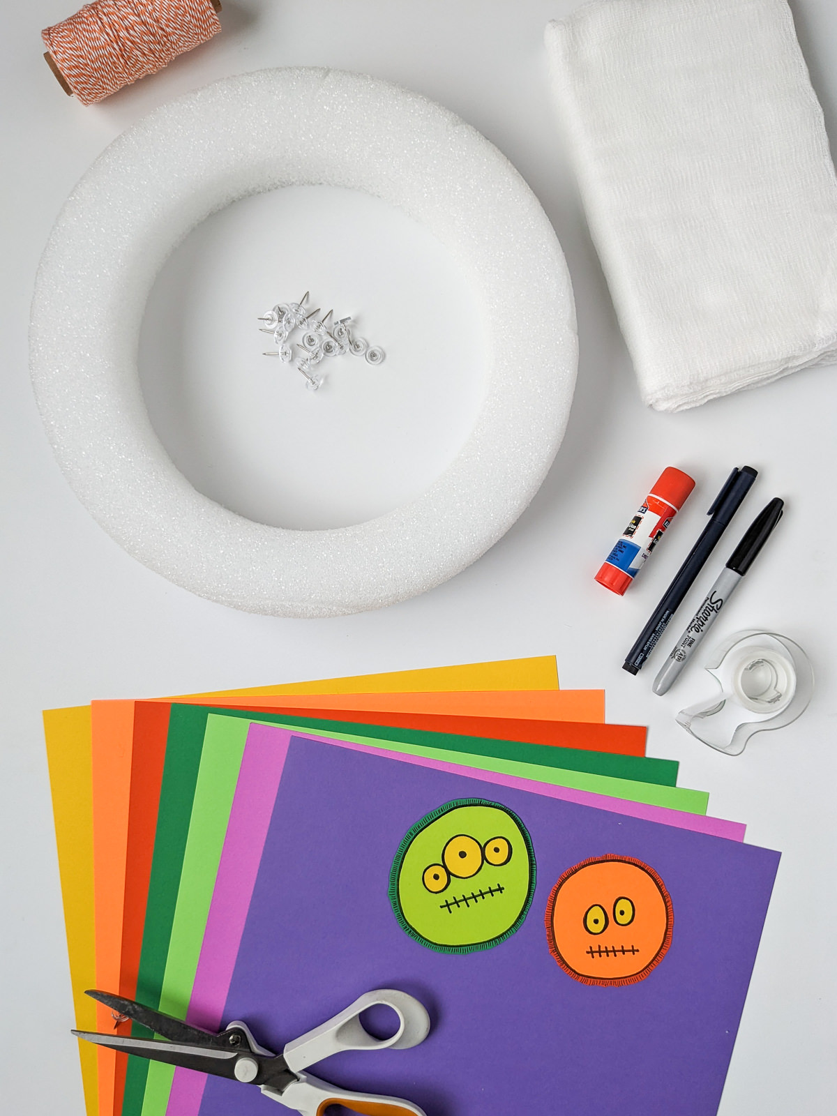 Craft supplies for making a DIY Halloween monster wreath Craft supplies for making a DIY Halloween monster wreath: Wreath form, paper, scissors, cheesecloth, push pins, glue stick