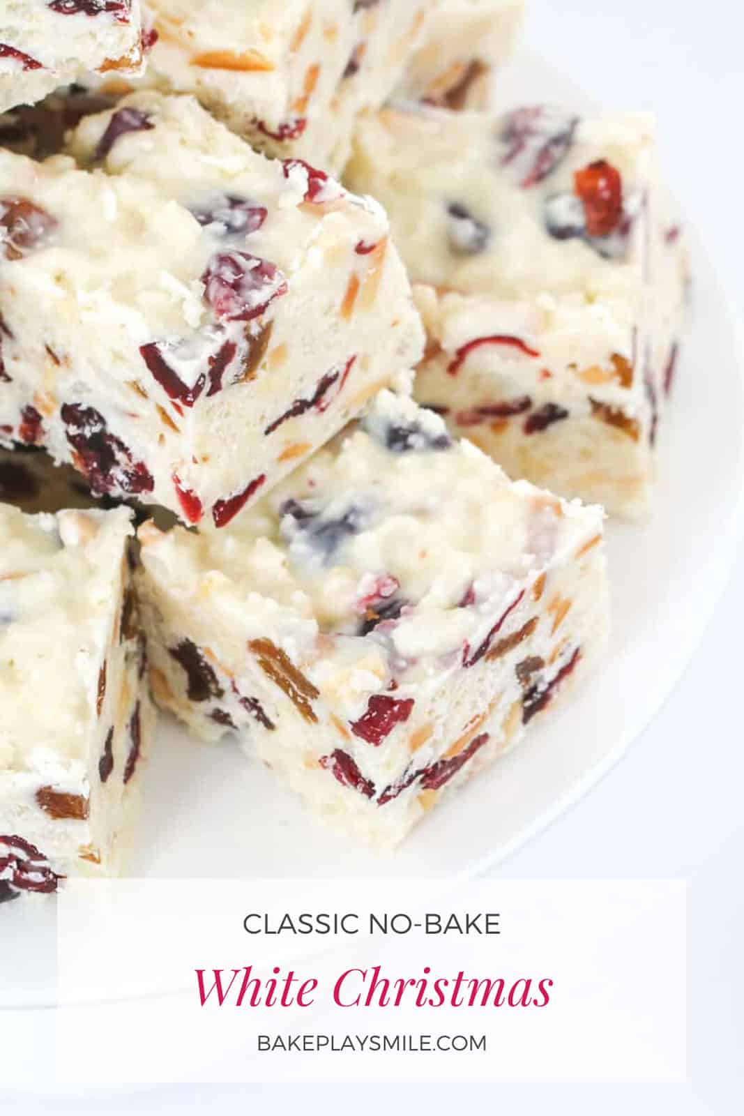 A stack of white christmas chocolate slice with dried fruit and nuts.