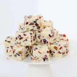 A simple White Christmas Slice recipe made with white chocolate, rice bubbles, dried cranberries, sultanas, coconut and almonds.