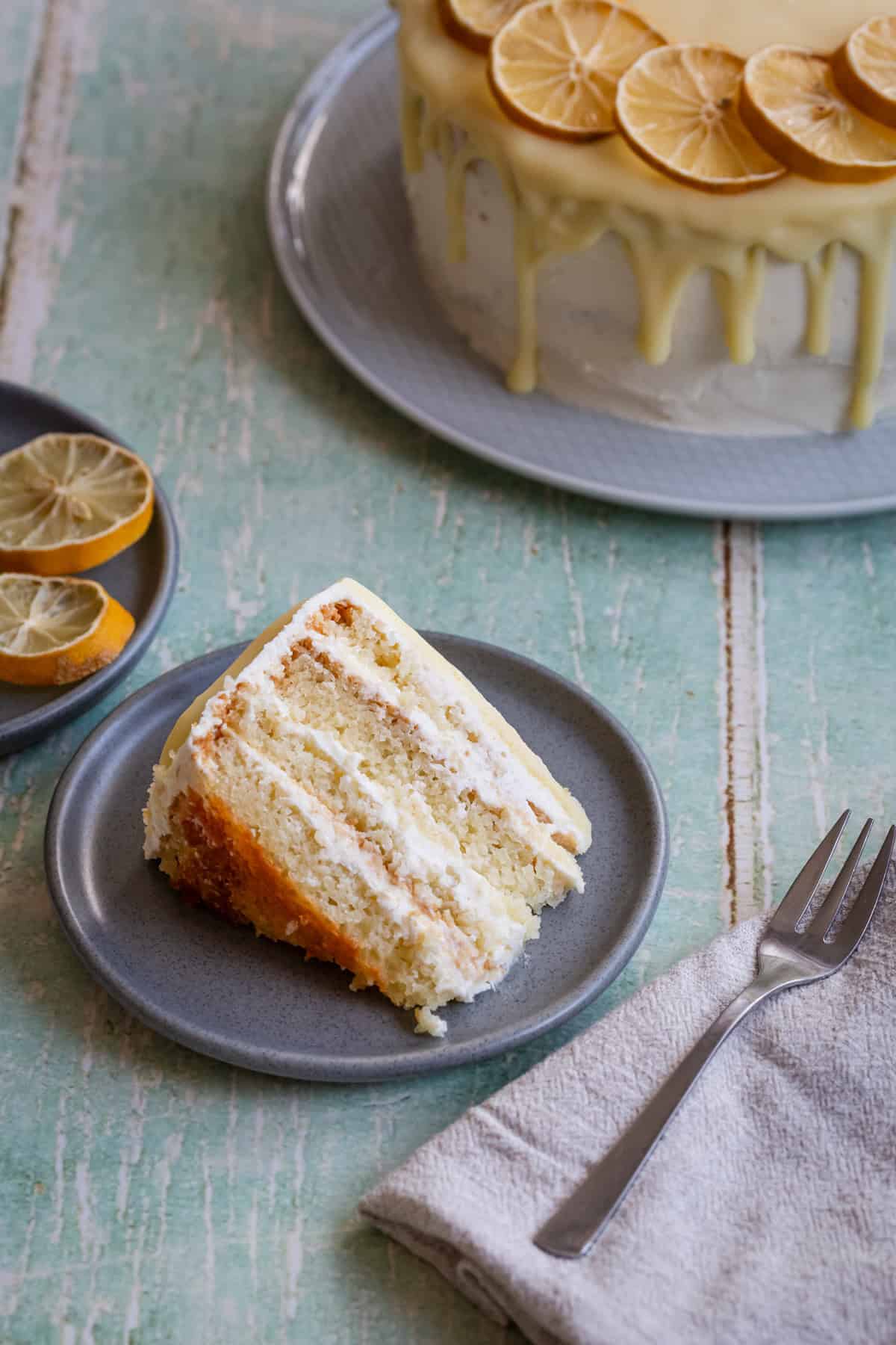 a slice of cake on a plate next to the big cake