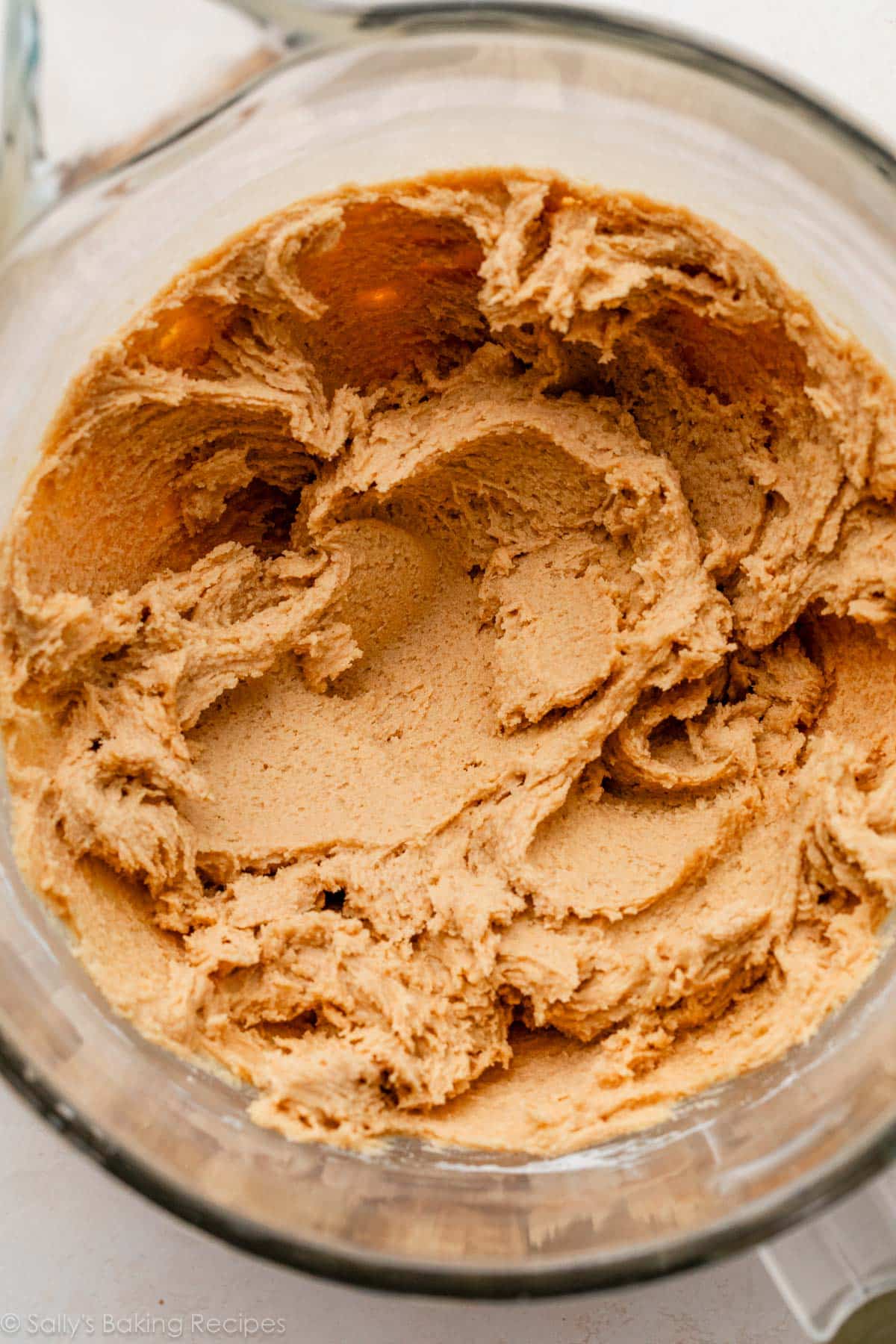 soft and creamy-looking peanut butter cookie dough in glass bowl.