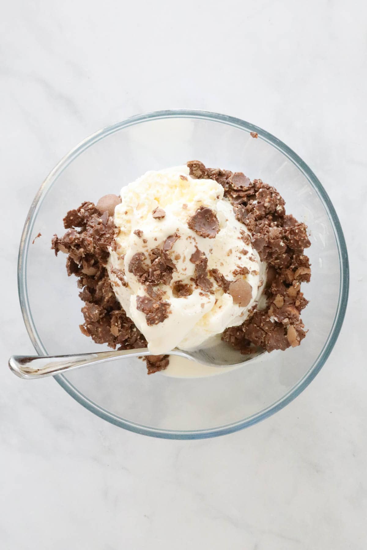 Vanilla ice cream with chopped Ferrero Rocher in a bowl.