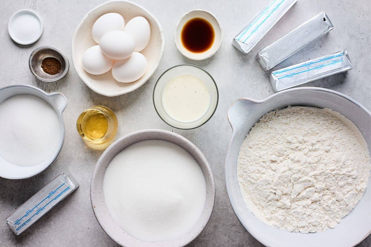 Ingredients to make eggnog pound cake on the table before mixing.