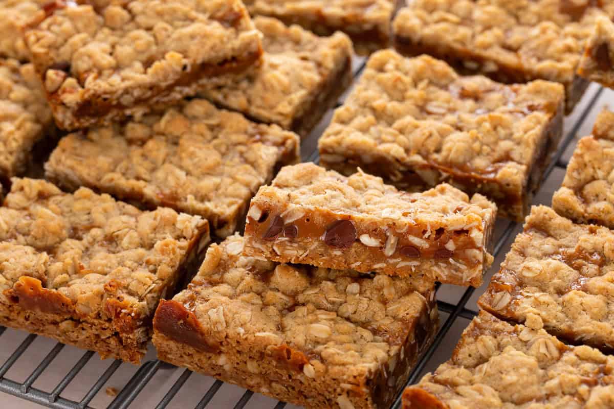 Sliced caramel pecan bars on a wire cooling rack.