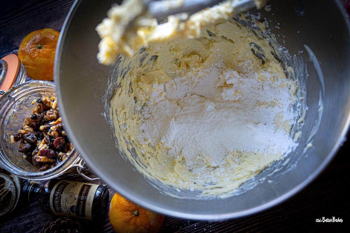 icing sugar added to beaten butter in a food mixer ready to be beaten