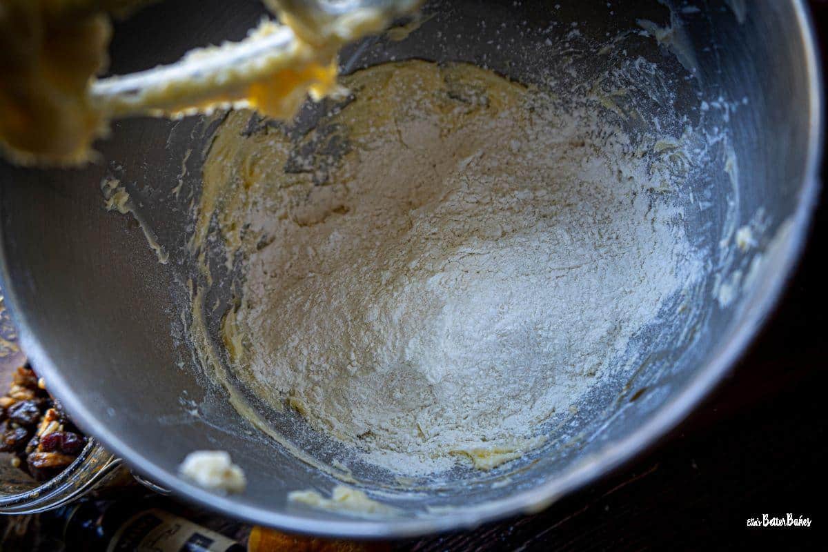flour mixture added to beaten butter and icing sugar ready to be mixed together