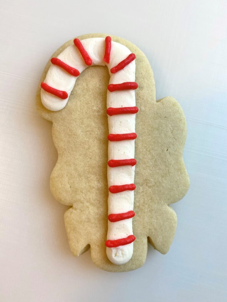 candy cane with bow decorated sugar cookie with buttercream