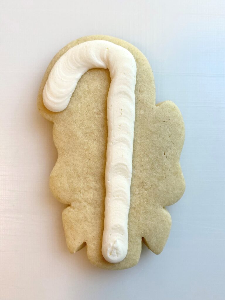 candy cane with bow decorated sugar cookie with buttercream