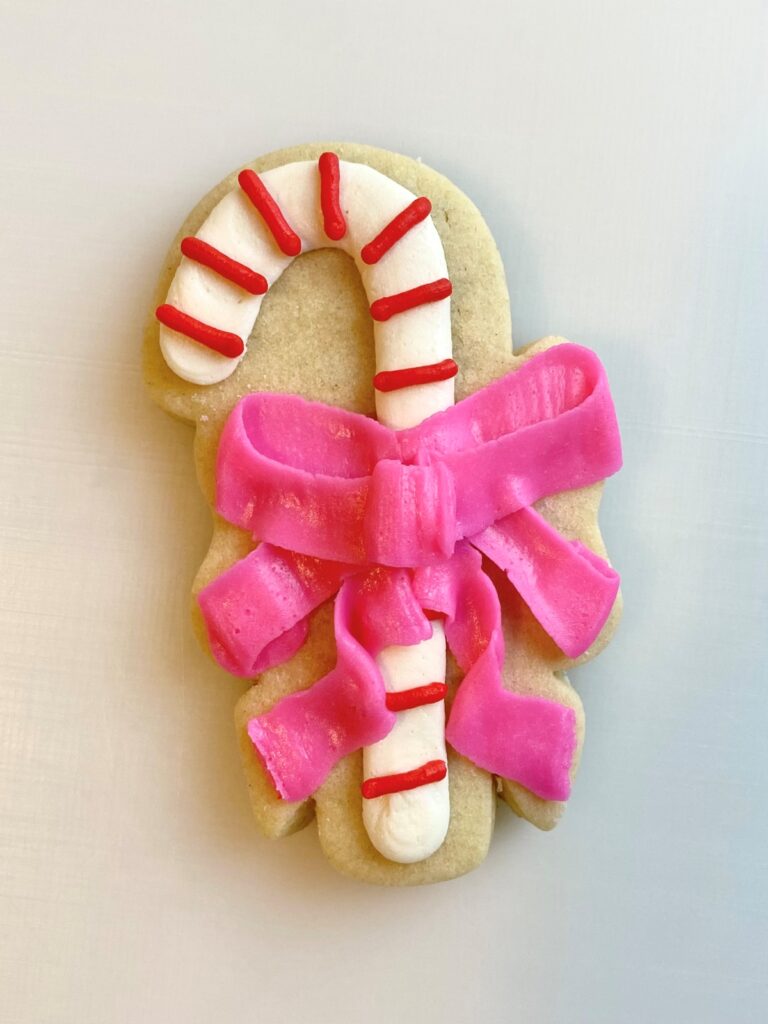 candy cane with bow decorated sugar cookie with buttercream