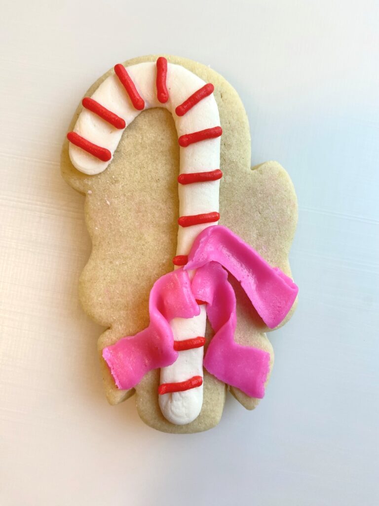 candy cane with bow decorated sugar cookie with buttercream