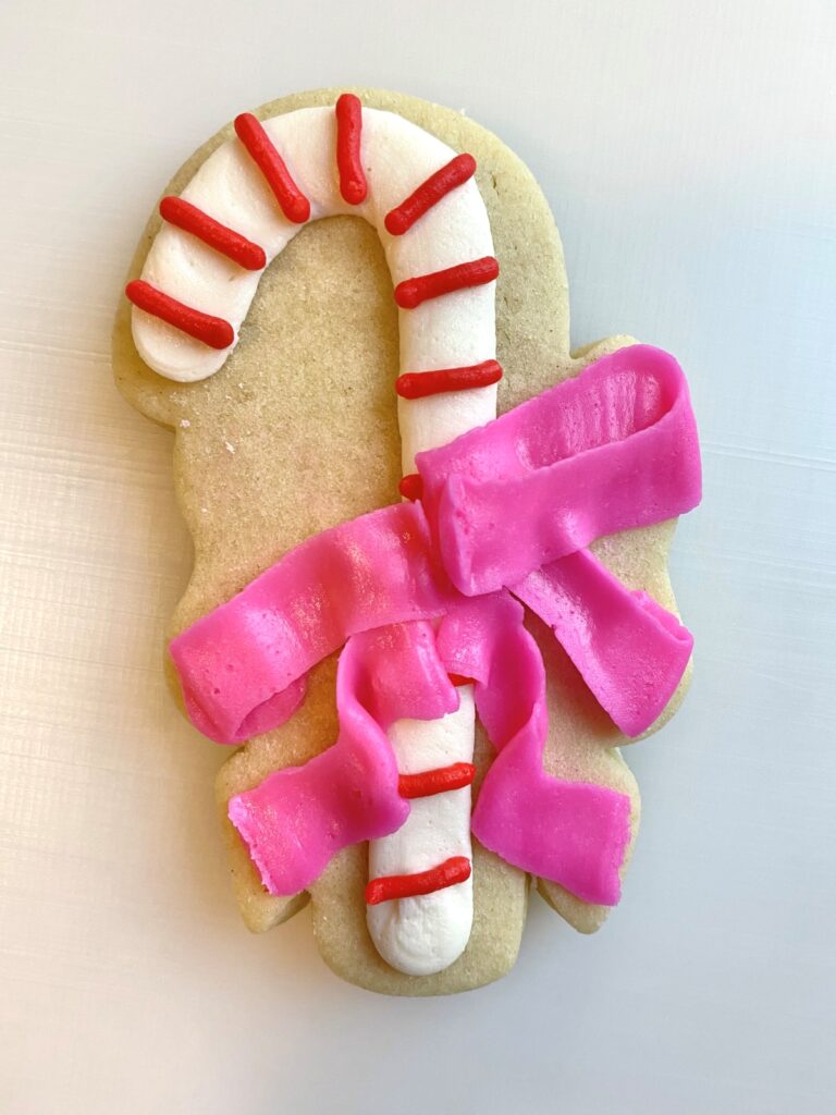 candy cane with bow decorated sugar cookie with buttercream