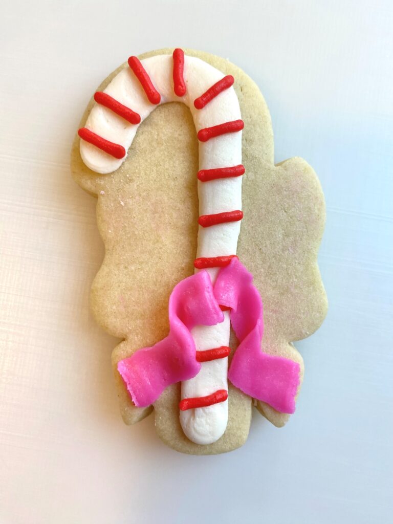 candy cane with bow decorated sugar cookie with buttercream