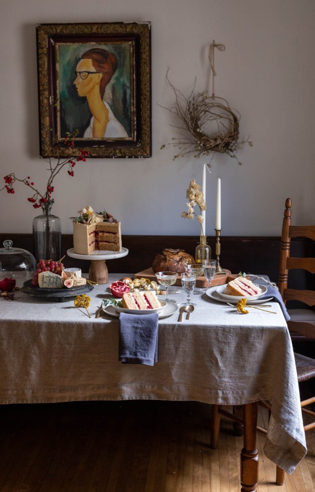 A fall table setting with spice cake with brown butter buttercream and cranberry filling