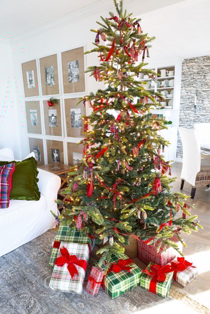 Simply decorated Christmas tree using strips of plaid fabric and red velvet ribbon.
