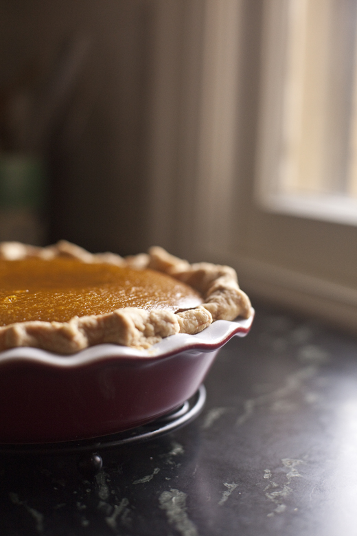 Caramel Apple Pumpkin Pie on a cooling rack by the window | ZoeBakes | Photo by Zoë François