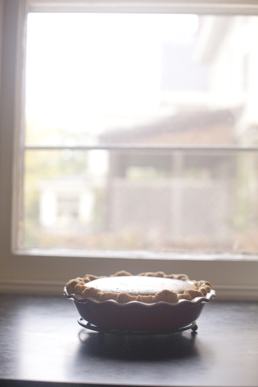 Caramel Apple Pumpkin Pie on a cooling rack by the window | ZoeBakes | Photo by Zoë François