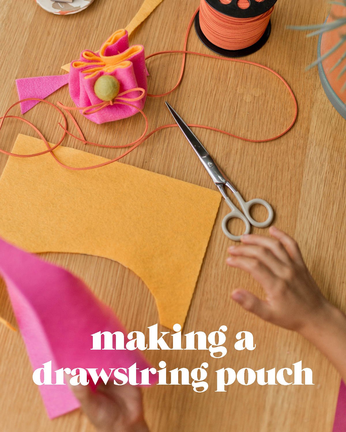 child making felt diy pouch with colorful sheets of felt and scissors