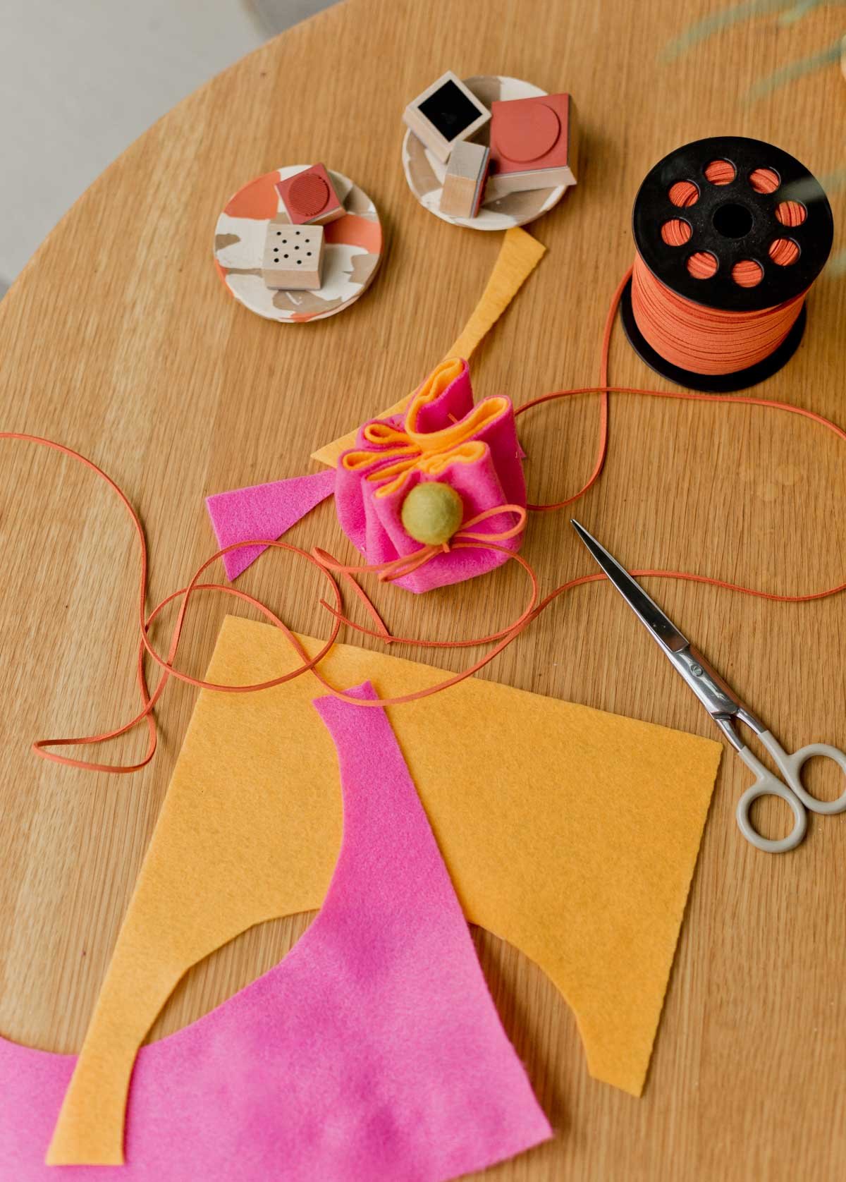 colorful sheets of felt being used to make a diy pouch from scratch
