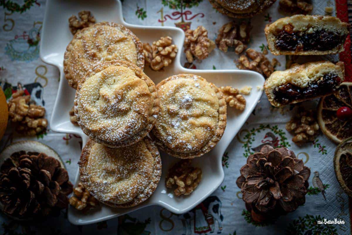 four viennese mince pies on a plate surrounded by christmas decorations