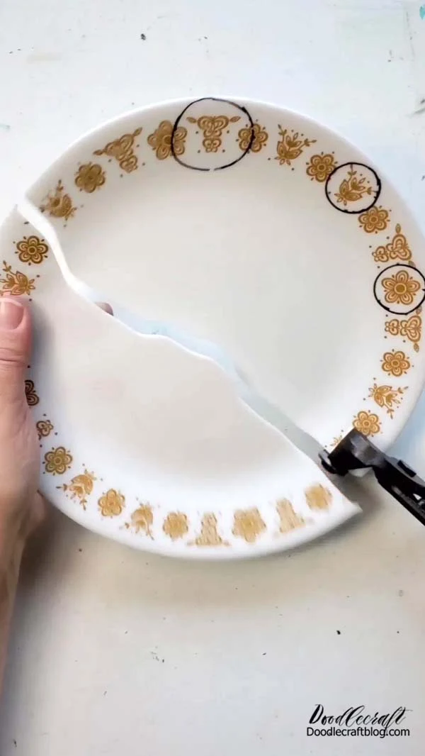 How to Make Corelle Plate Necklace Jewelry DIY! Step 2: Cutting Use the Tile Cutting Pliers (2 round disks that cut through glass and tile) to cut into the plate. This part was the first time I ever used the tile cutters, so I didn't know how well they would cut or how precise I could be, so I just cut the plate in half. The pliers are actually really precise in cutting a line wherever they are placed. Experiment with them a bit and then cut out the shapes you've outlined.