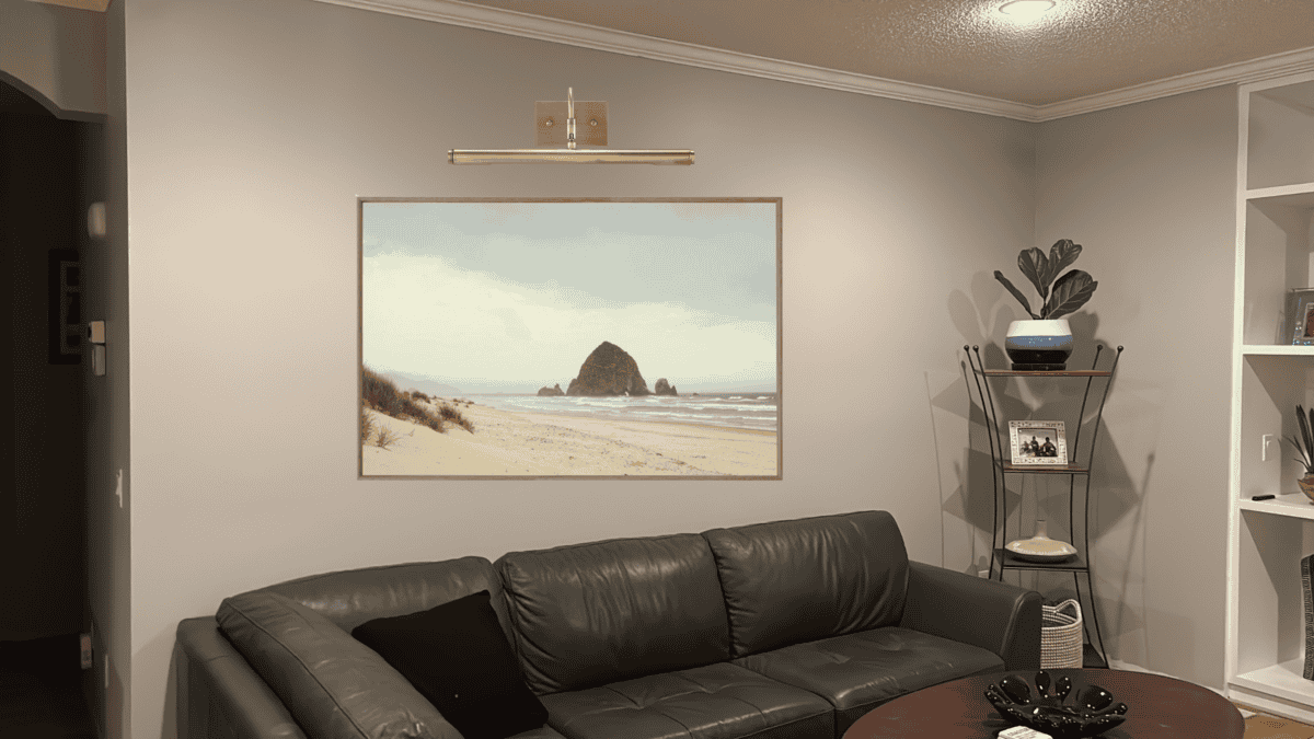 Adding statement art over a couch with a picture light